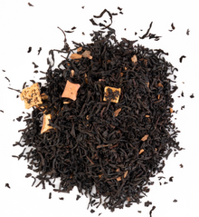 Warm Ceylon black tea with cinnamon and apple pieces on a white background