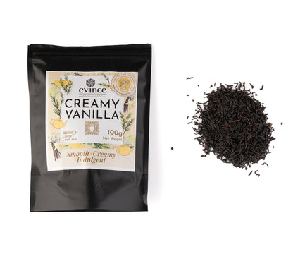 Creamy vanilla tea with loose black tea leaves and vanilla beans with its pack on a white background