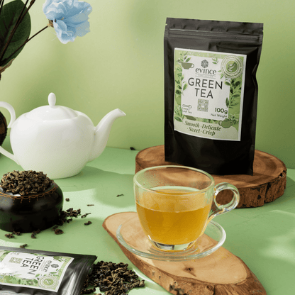 Evince ceylon green tea prepared in a cup with its pack nearby