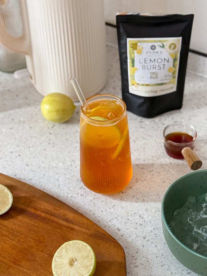 Evince Lemon Burst fruity tea prepared in a glass jar with its pack nearby