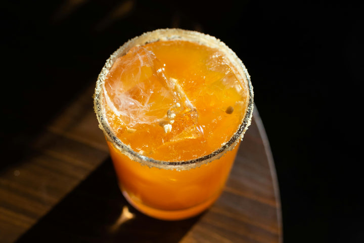 A flatlay image of an iced tea on a wooden table