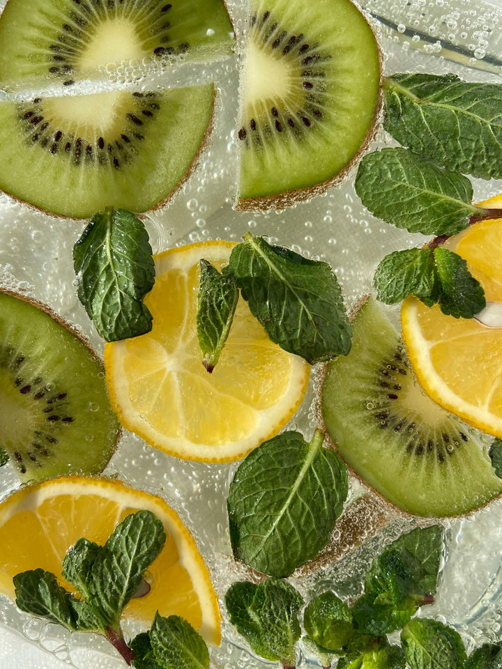 A refreshing image of lemon, kiwi and basil leaves 
