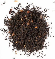 Aromatic Ceylon black tea with whole spices like cinnamon, cardamom, and cloves on a white background