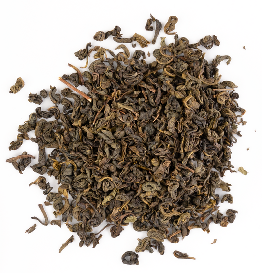 Loose leaf green tea blended with fresh mint leaves on a white background