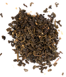 Ceylon green tea blend with dried peach and ginger on a white background.