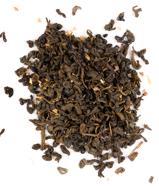 Ceylon green tea blend with dried peach and ginger on a white background.